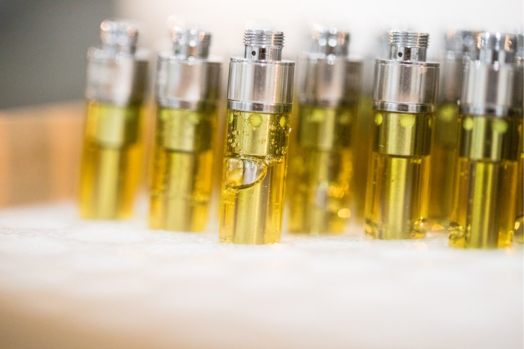 A variety of Dank Vapes cartridges in yellow and silver bottles on a table